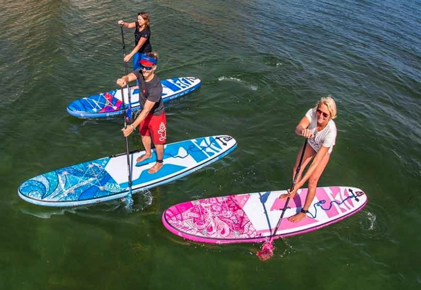 Paddlers on Starboard iGos stand up Paddle boards with starboard leashes and paddles